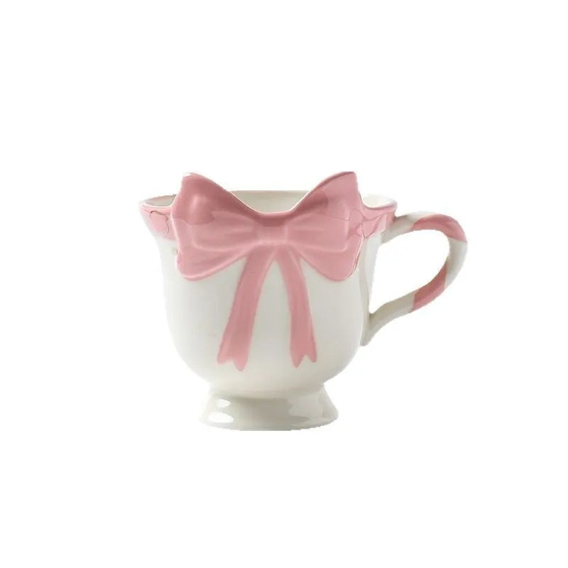 Ceramic mug with bow and heart design in white powder or black pink colours