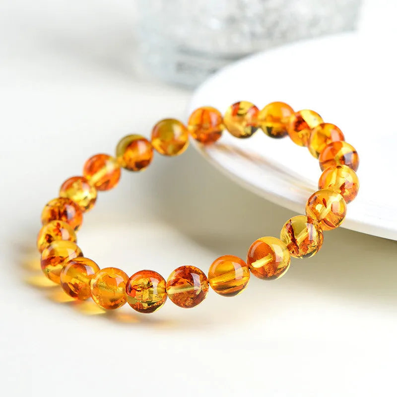 Natural yellow piebald amber bracelet with geometric polished beads showing flower spot patterning