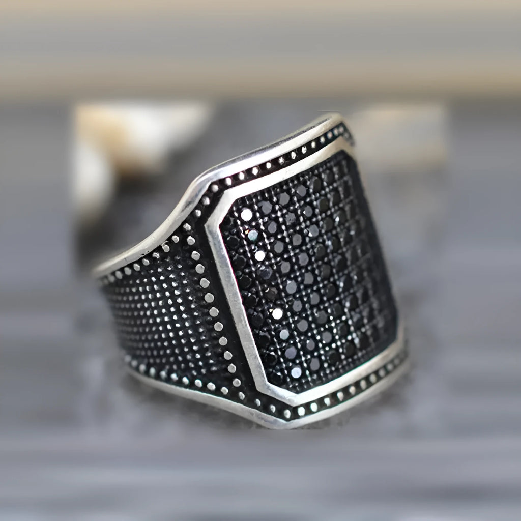Black alloy ring with copper inlay and zircon stones showing sizes 7 to 13