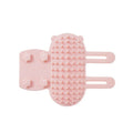 Silicone cat grooming comb with adjustable strap fastened to a table leg for self-cleaning