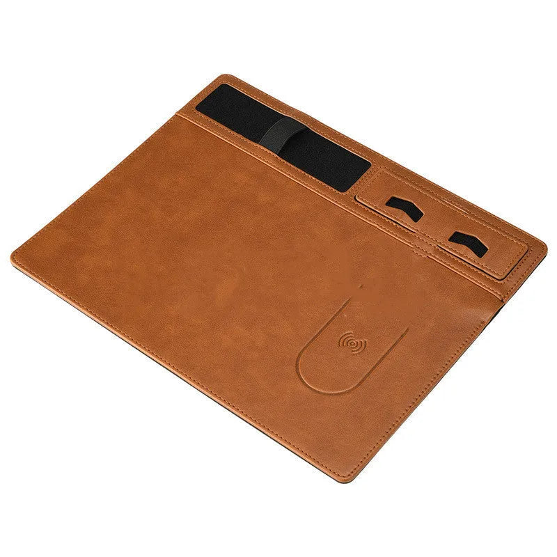 Pink wireless charging mouse pad with integrated phone holder on a desk, showing 320 x 260 mm size.