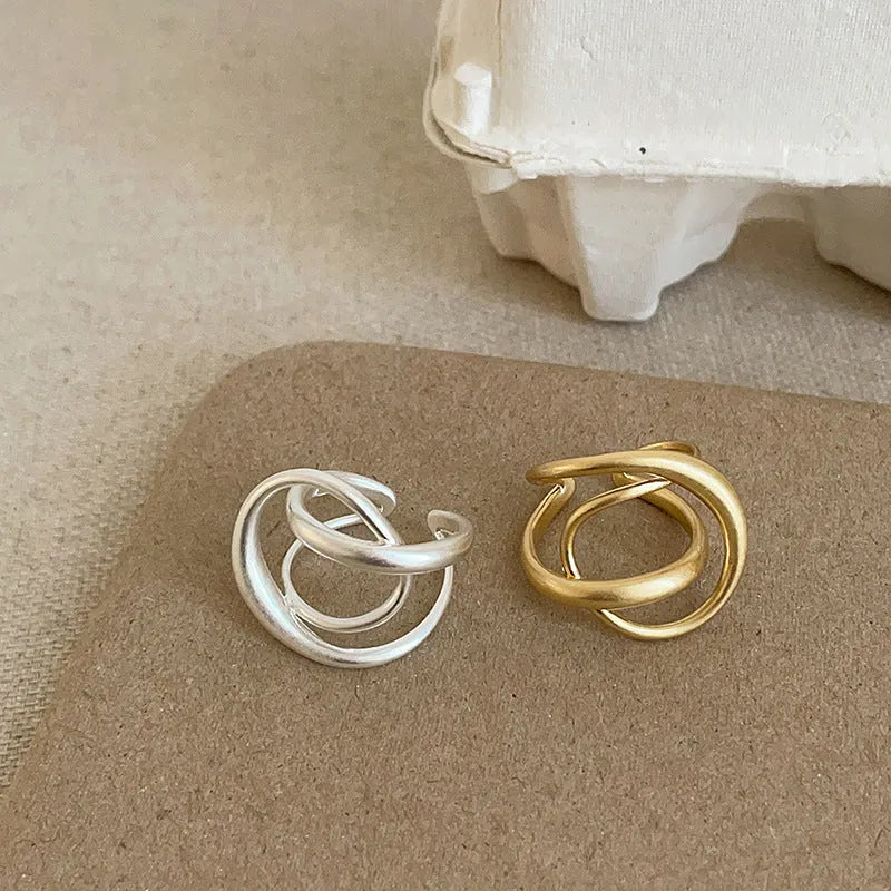 Geometric open ring with three-dimensional interlaced matte metal design in gold or silver electroplated finish