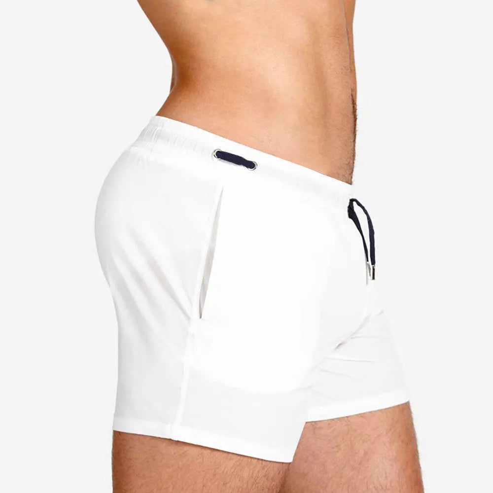 Men's solid colour polyester swimming shorts with mesh lining, shown in multiple colour options.
