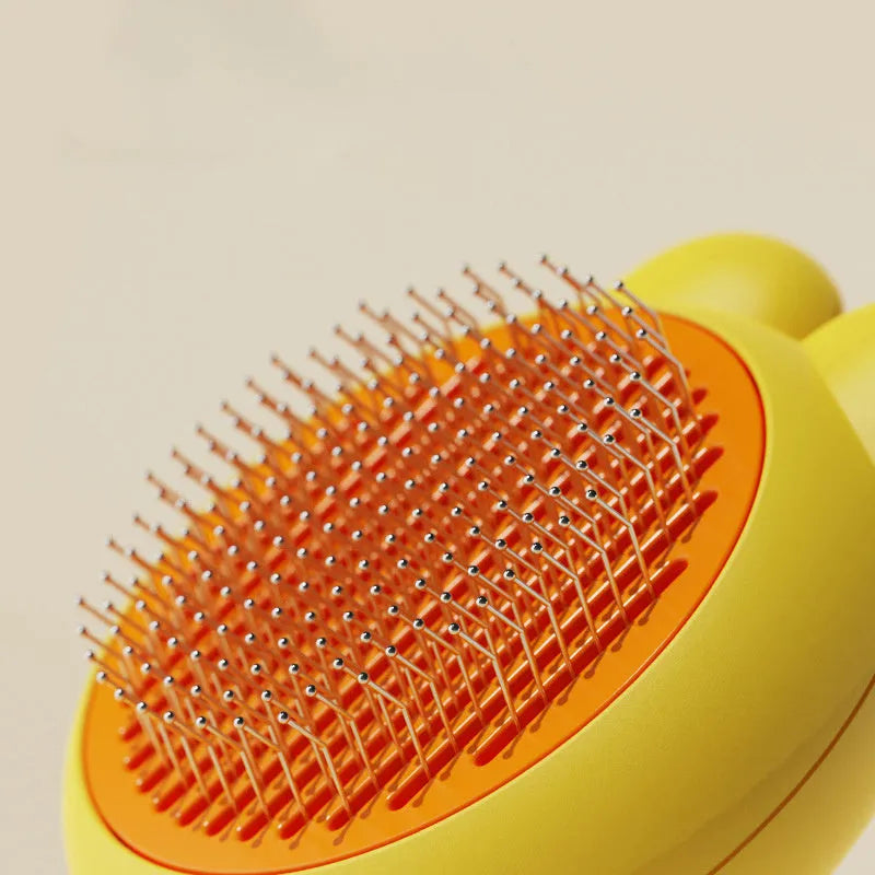 Green self-cleaning pet grooming brush with a stainless steel comb and a comfort-grip handle.
