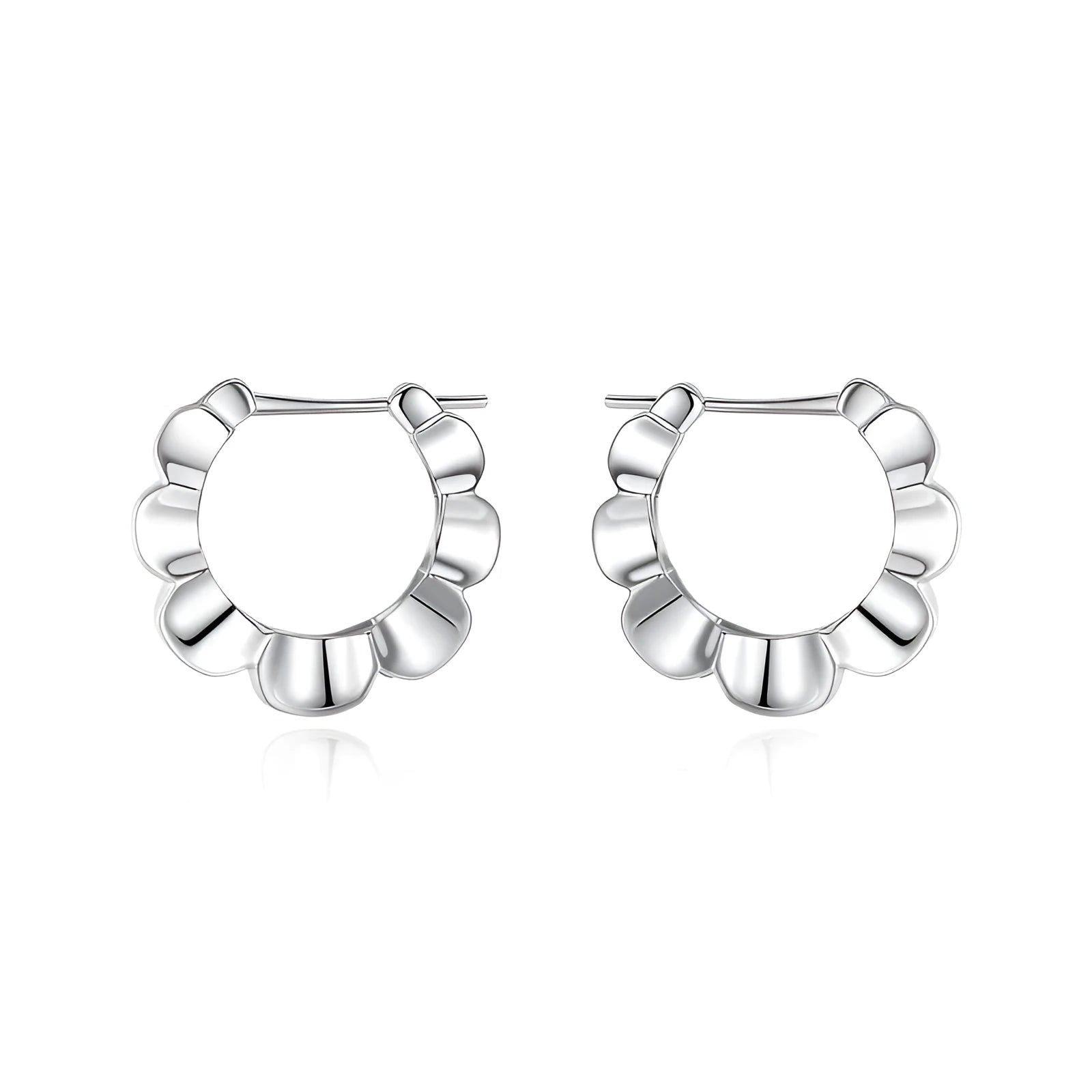 A pair of sterling silver geometric earrings with round details on a simple background.