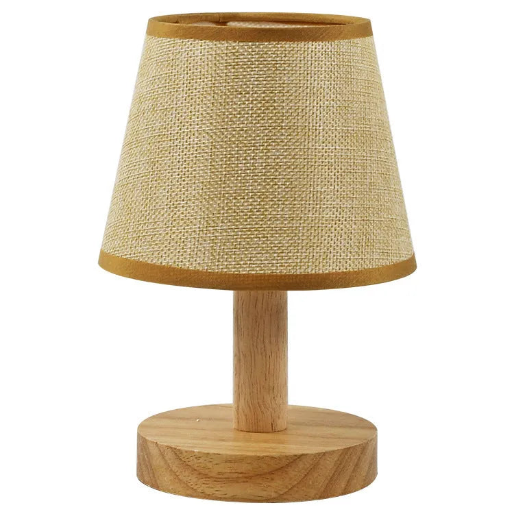 Vintage pleated table lamp with jute shade and bamboo base on a wooden table.