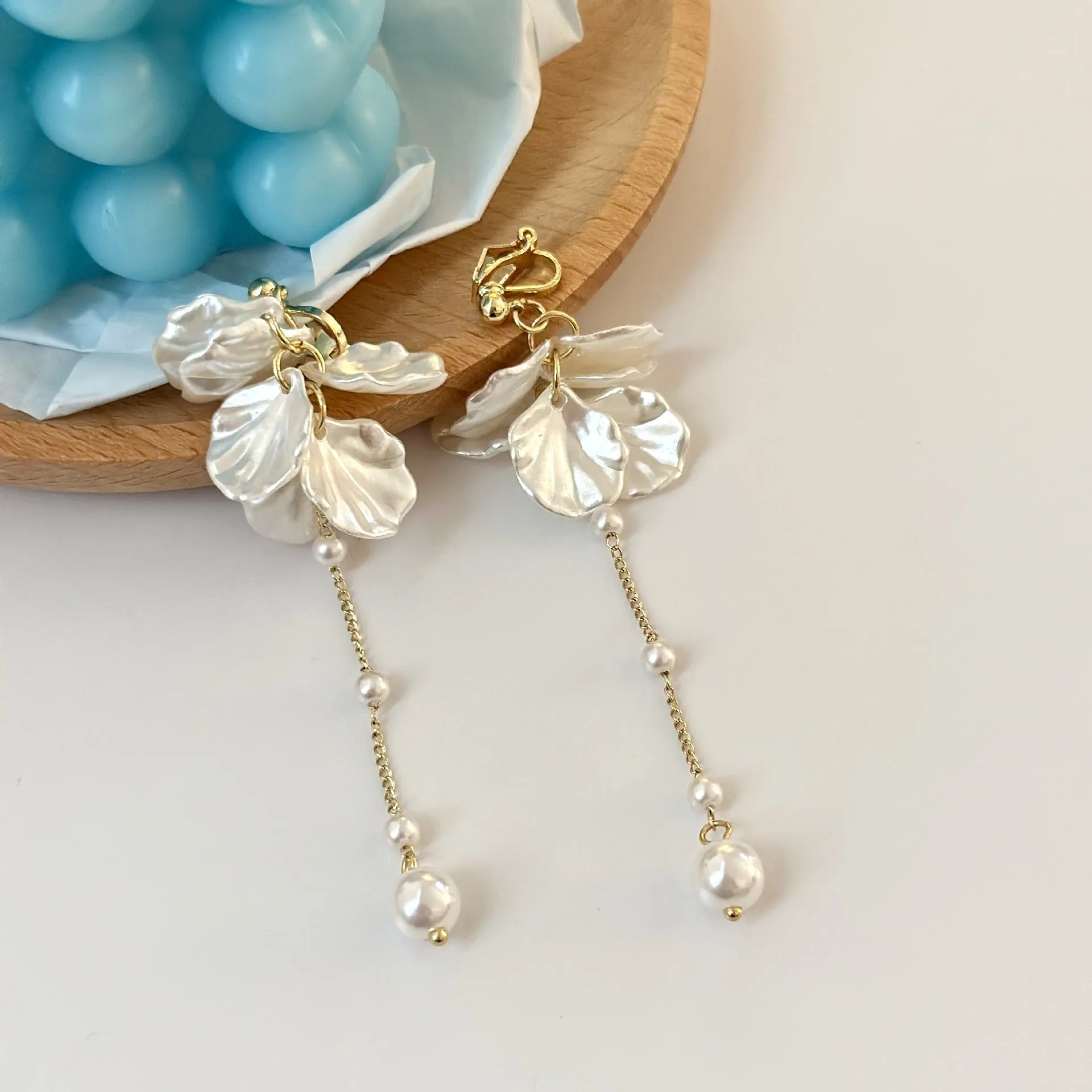 Long shell pearl tassel earrings with acrylic construction and multiple ear clip options