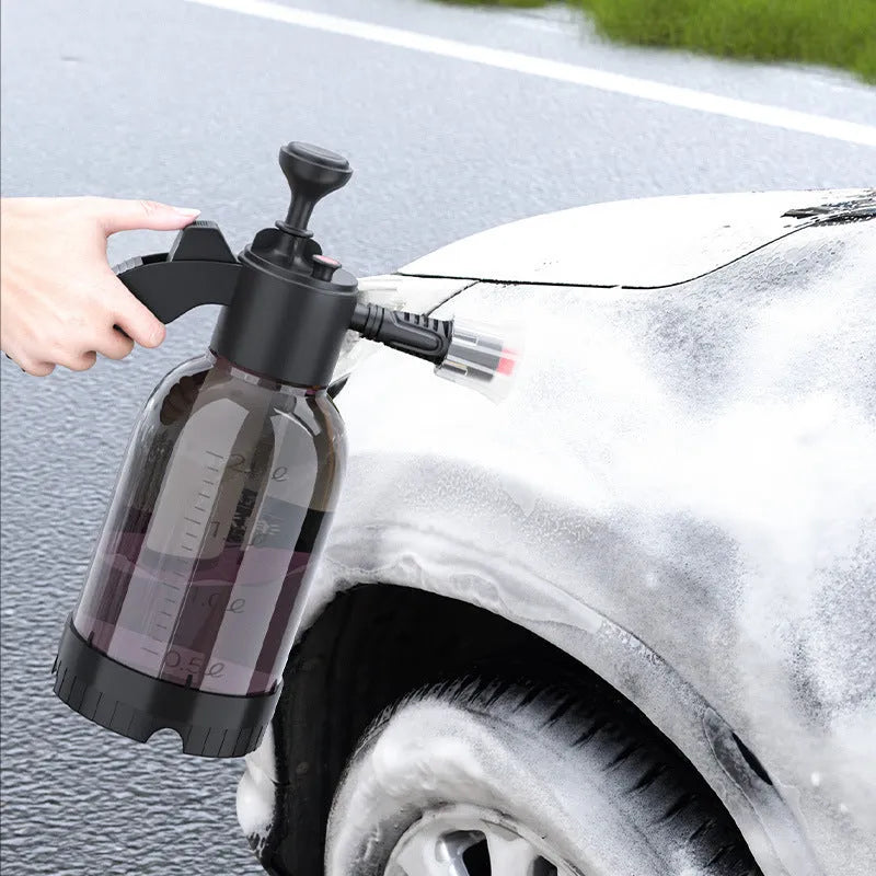 Black 2 litre handheld foam spray watering can with a comfortable handle and two nozzle attachments.