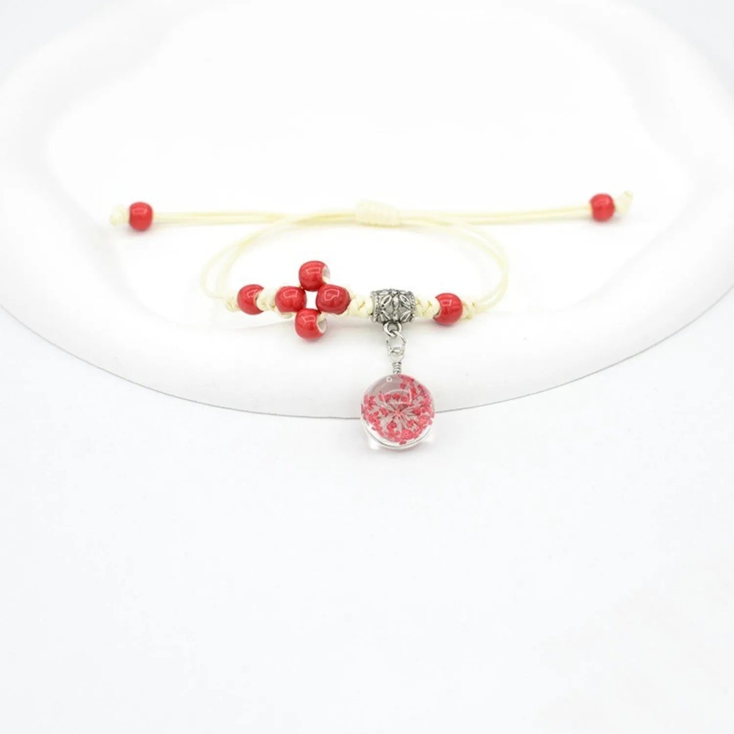 Glass dried flower bracelet with large 1.4 cm beads containing real preserved flowers in hand-woven lace design