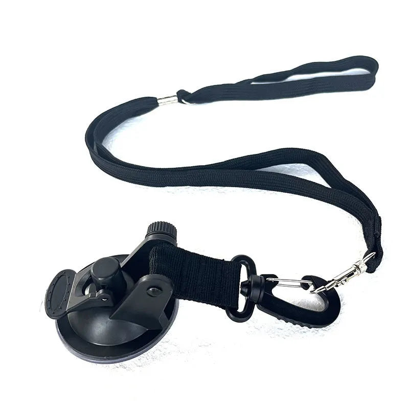 Pet bathing restraint tool with large suction cups, handcuffs, and a connecting rope on a bathroom tile background.