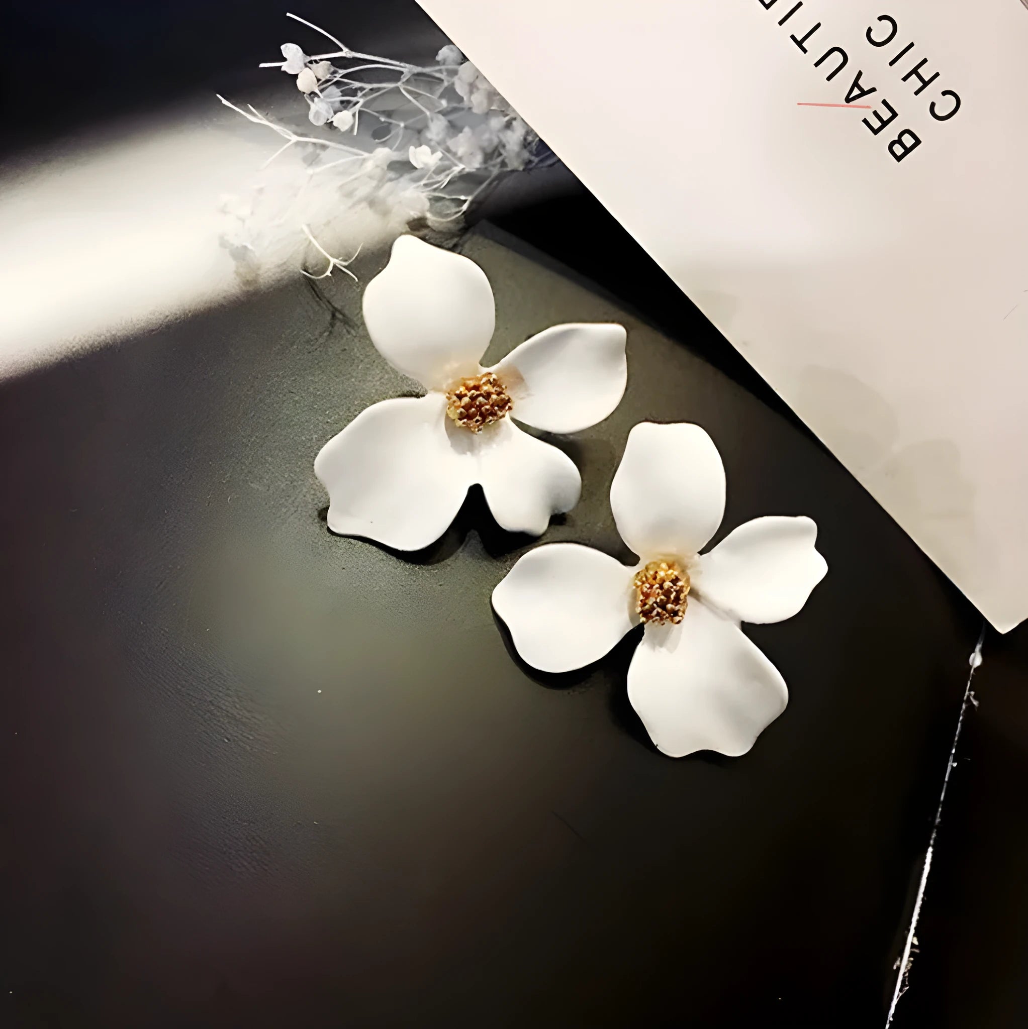 Flower shape stud earrings in pink and white colours with electroplated finish