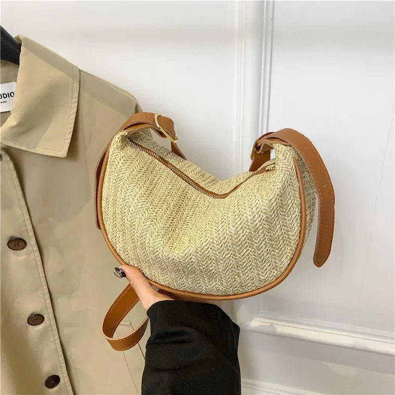 Women's woven straw crossbody bag showing internal phone pocket and file compartment