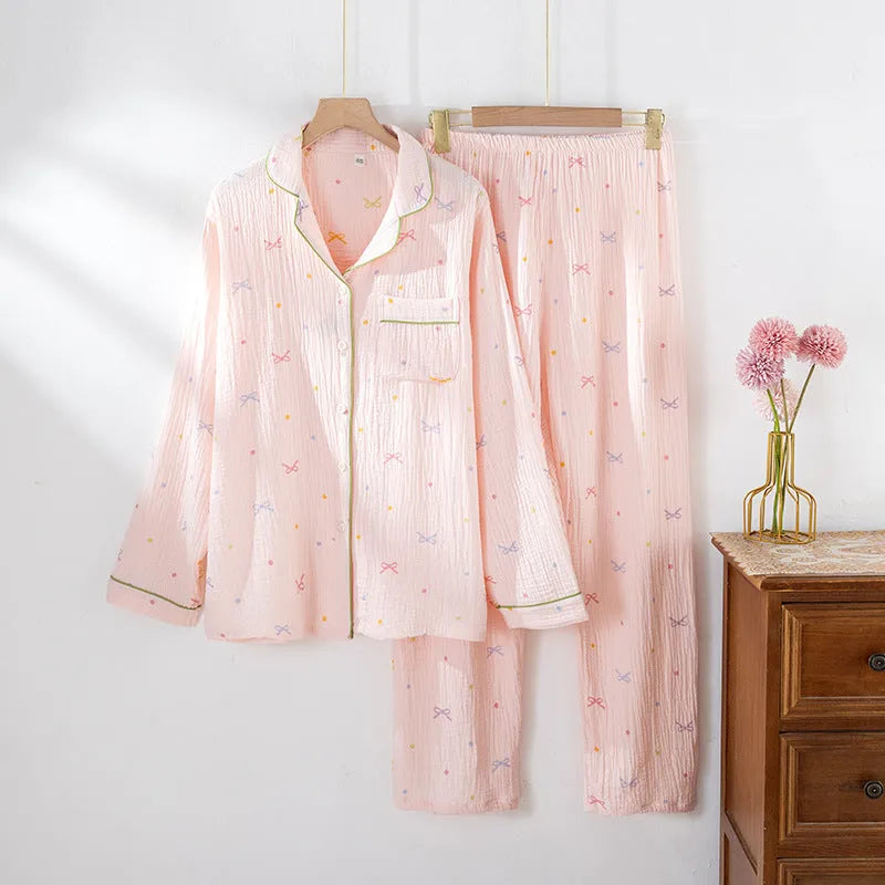 Women's cotton pajama set in pink colour with long sleeves and trousers on hanger