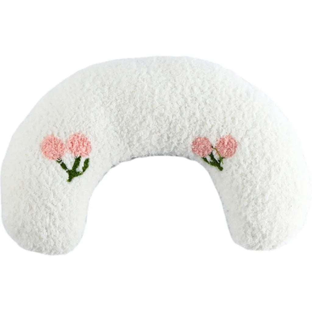 Small white U-shaped plush pet pillow for cats and small dogs on a neutral background.