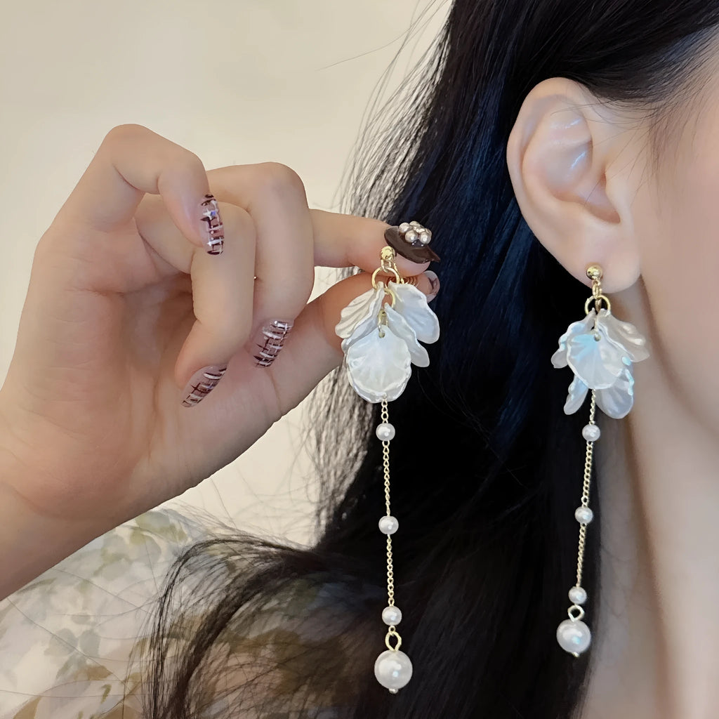 Long shell pearl tassel earrings with acrylic construction and multiple ear clip options