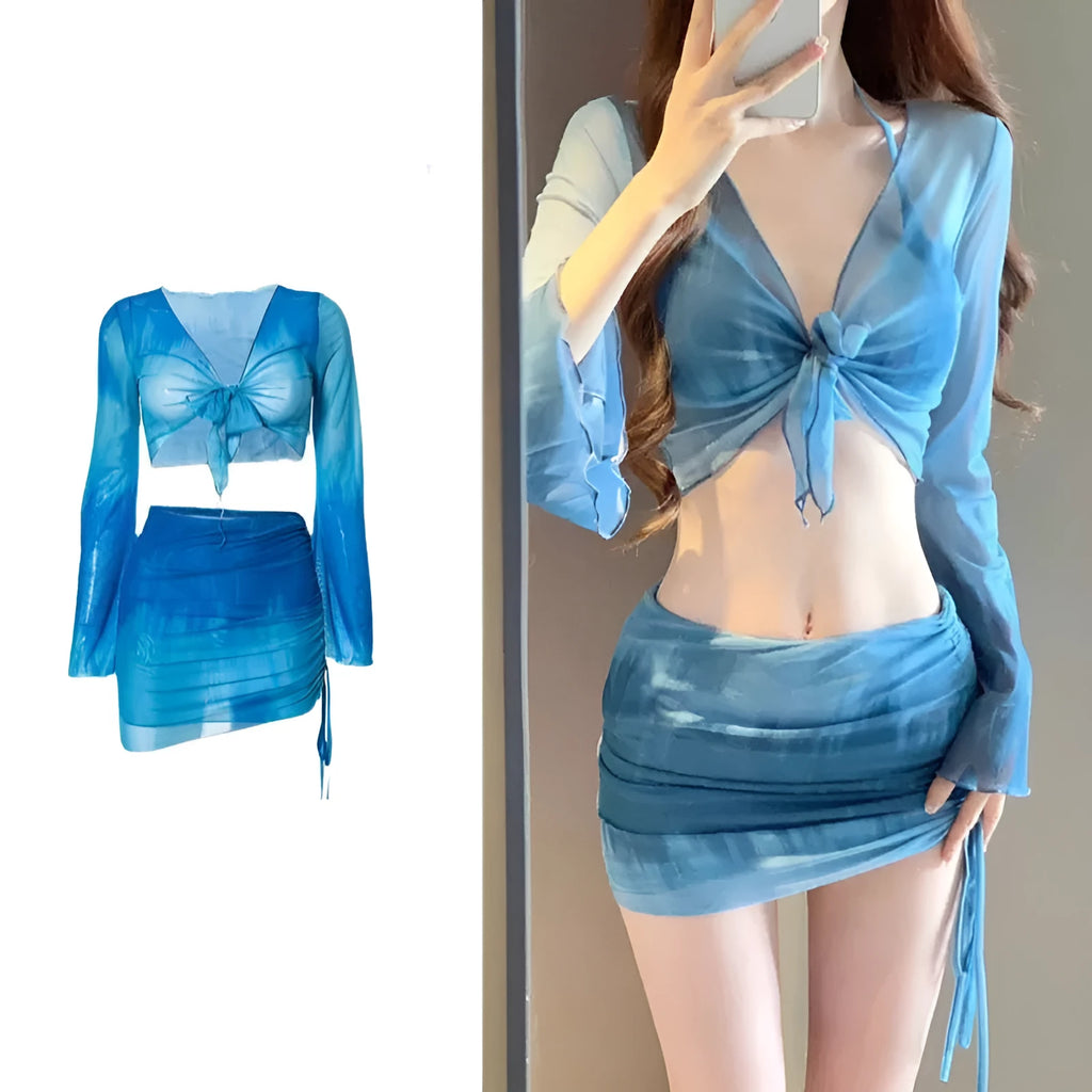 Women's blue four-piece bikini set with high-waist briefs, backless top, and coordinating skirt