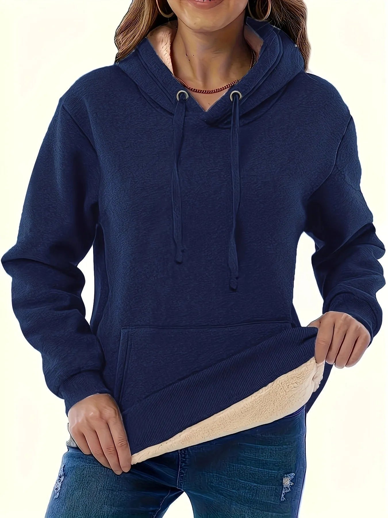 A women's loose fit hooded sweater in thick grey polyester with side pockets and long sleeves.