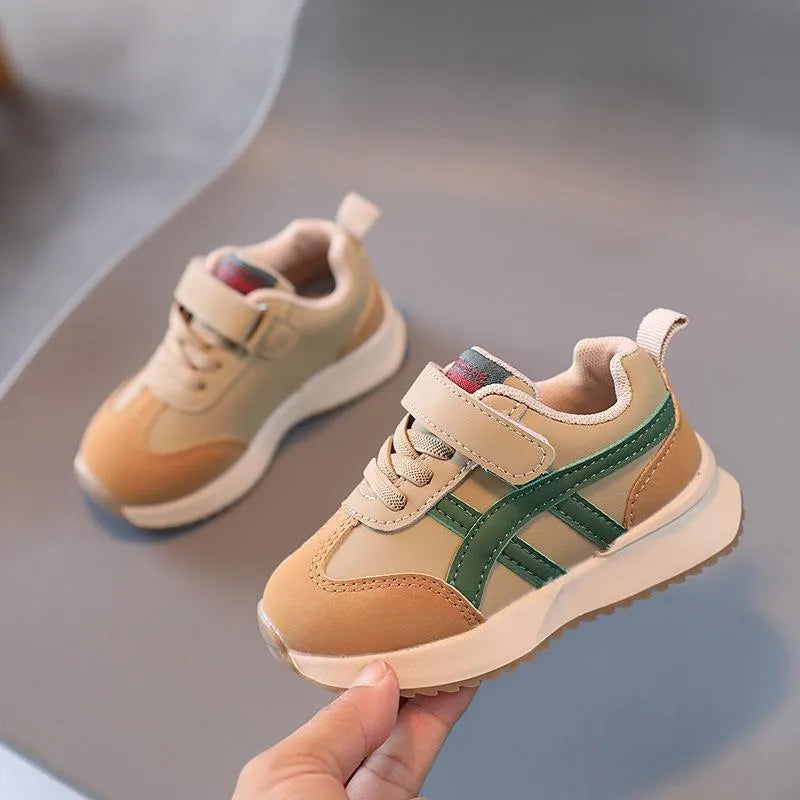 Children's white casual sneaker with Velcro strap on a non-slip rubber sole.