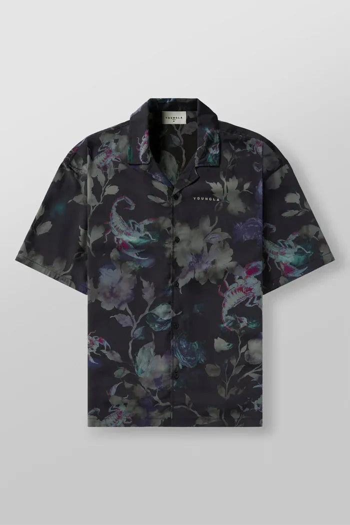 A man's loose-fitting, short-sleeve casual top with a floral print, shown in a light colour.