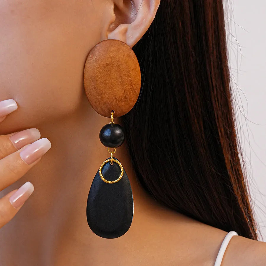 Brown-black wooden earrings with silver needle accents in elliptical European style design