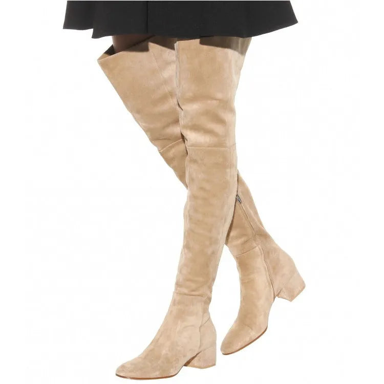 Grey suede women's over the knee flat boots with a pointed toe and low block heel on a neutral background.
