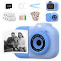 Blue children's digital camera toy with video recording, games, and photo sticker functions on a table.
