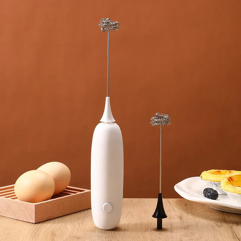 Black and white electric milk frother handheld blender for coffee drinks