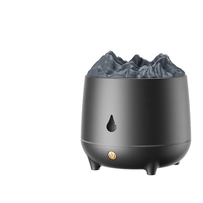 Black volcano-shaped ultrasonic humidifier with USB cable on a wooden table, emitting a plume of mist.