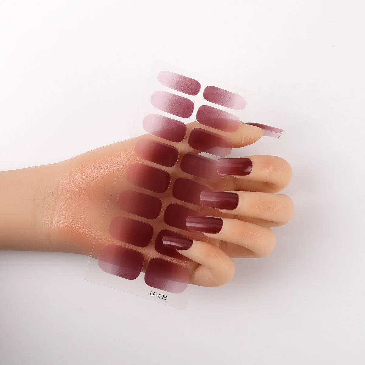 Set of 16 solid colour nail art stickers showing floral, geometric, and pattern designs for manicure application