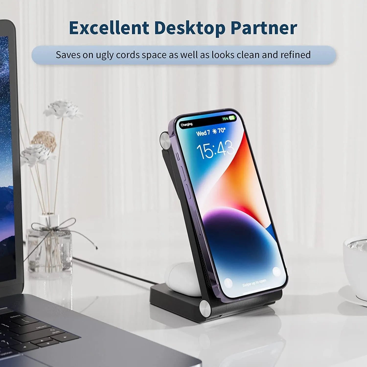 New vertical folding magnetic three-in-one wireless charger in black on a desk charging a smartphone, watch, and earbuds