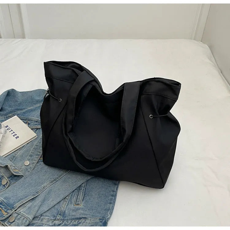 Soft Oxford cloth commuter tote bag in a street style, shown in a folded position.