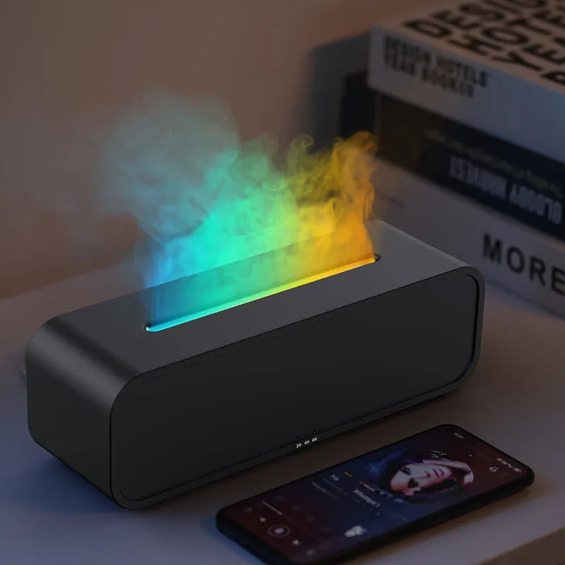 Black and white USB essential oil aroma diffuser with colour-changing light and remote control on a desk