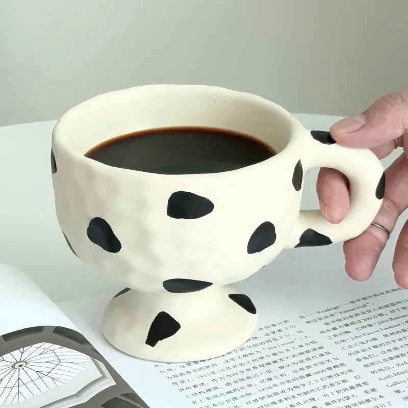 Handmade ceramic mug with irregular shape in solid colour