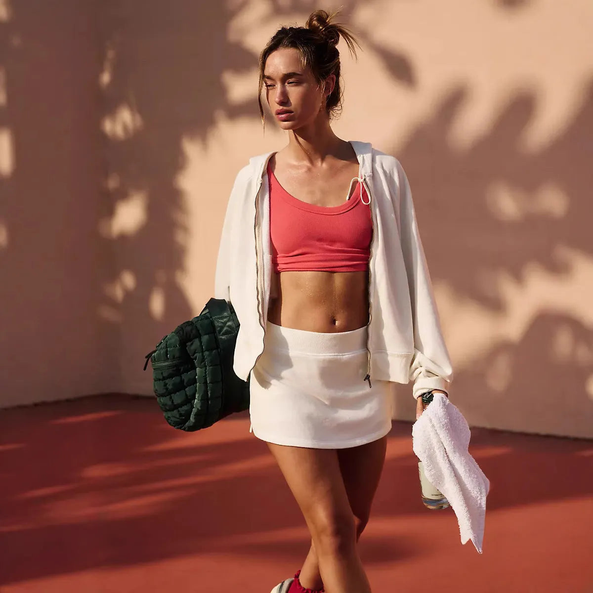 Women's casual street style outfit with hooded jacket and matching mini skirt in solid colour