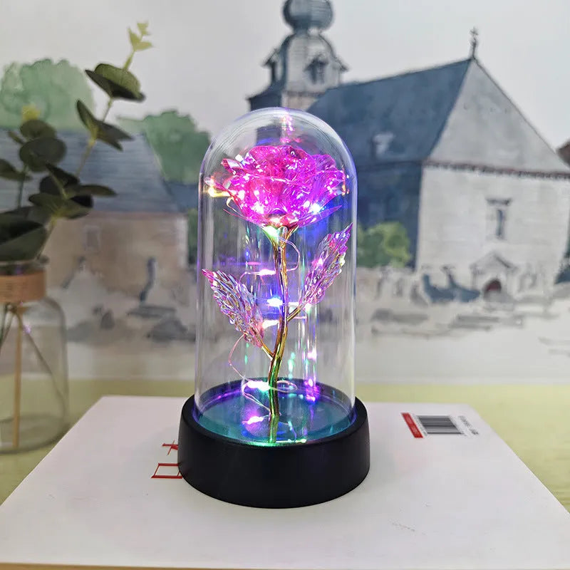 Small plastic night lamp with glass cover and flower decoration on black base