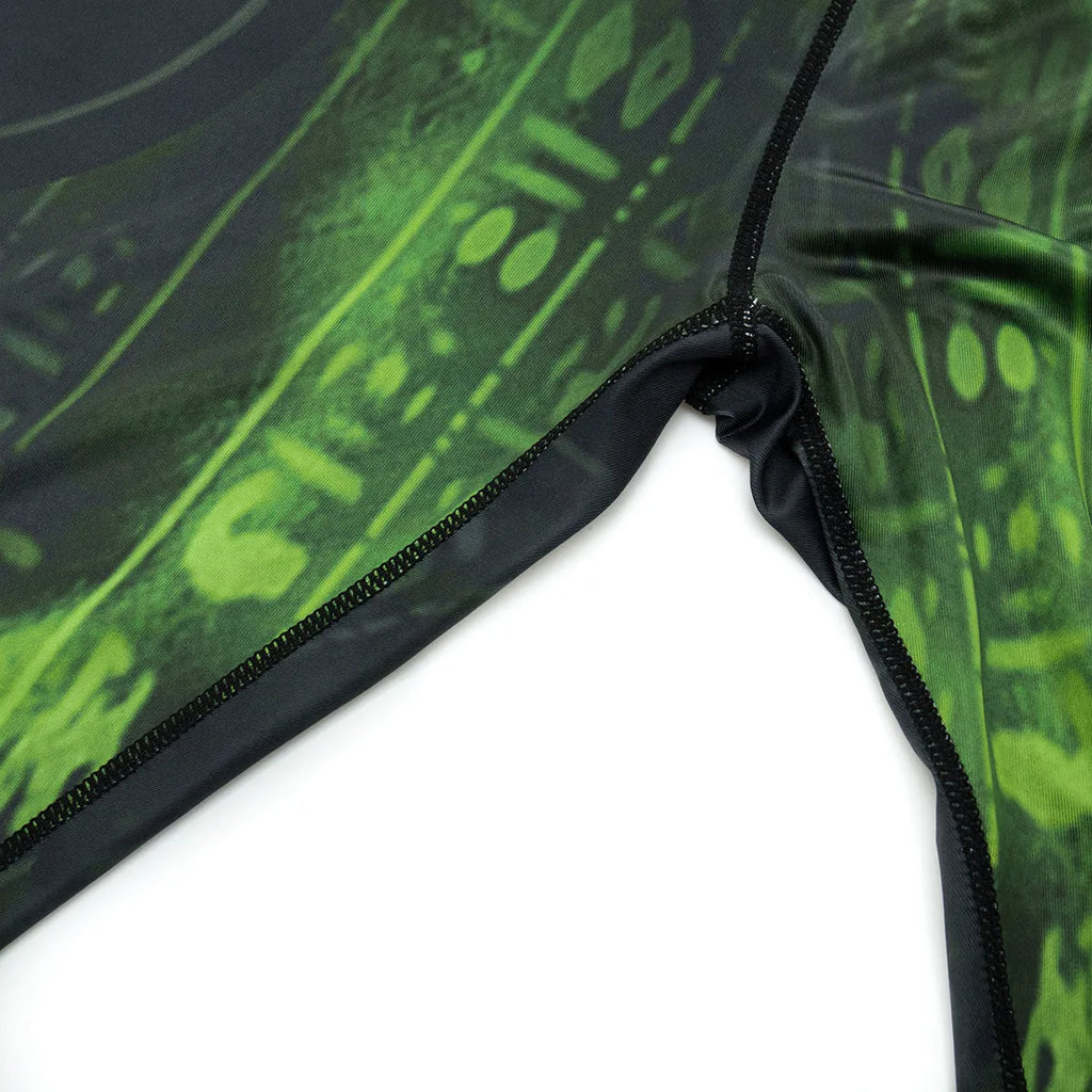 Man wearing a slim-fit, long-sleeve printed sport suit for running or gym training.