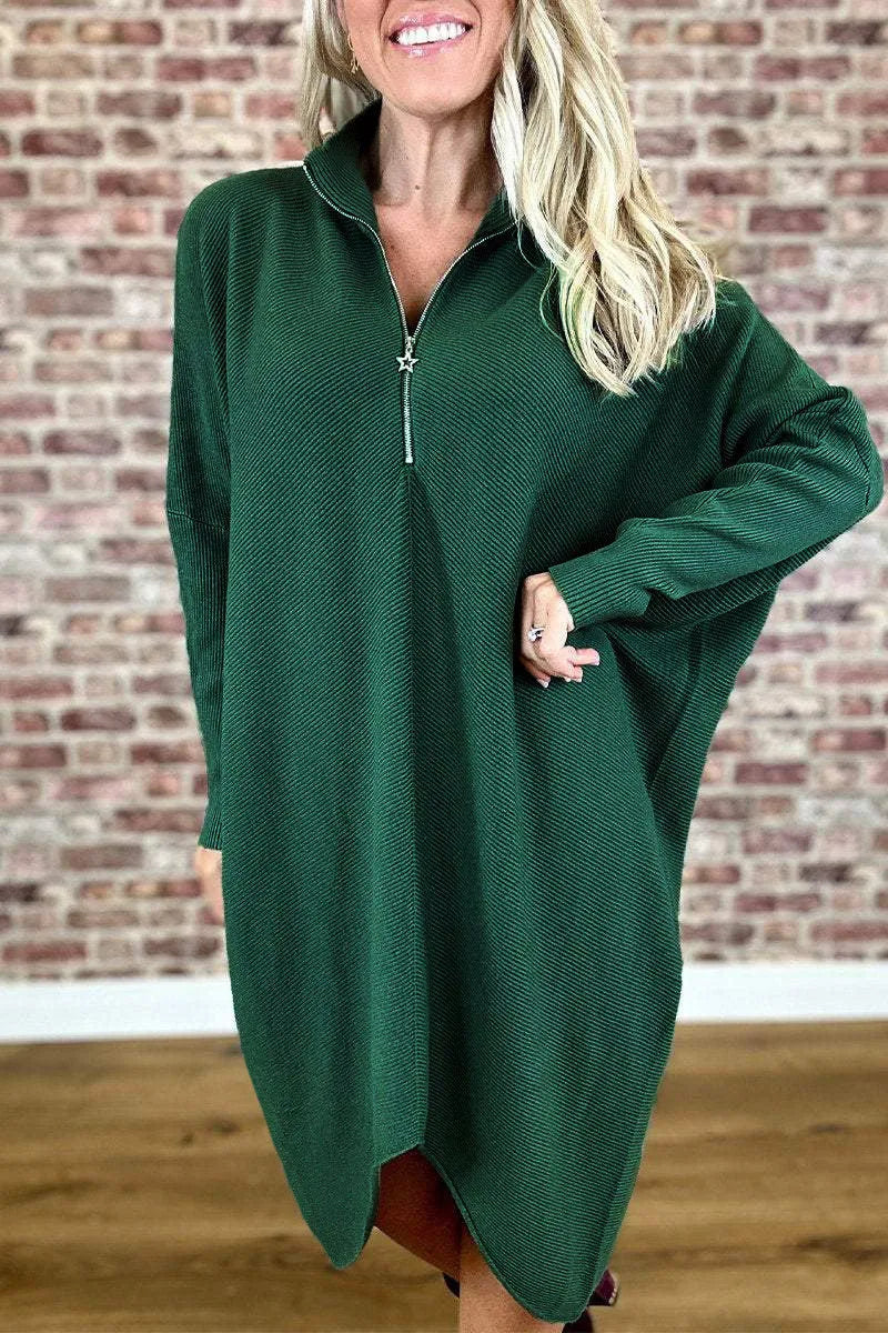 Women's solid colour loose fit knitted dress with raglan sleeves on a model.