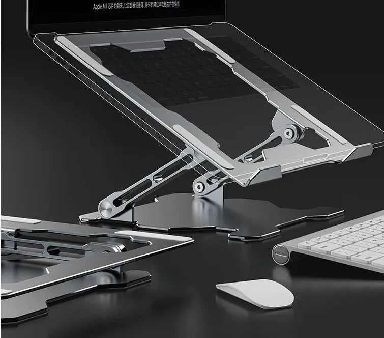 Grey aluminium folding laptop stand holding a silver laptop at an angle on a wooden desk.
