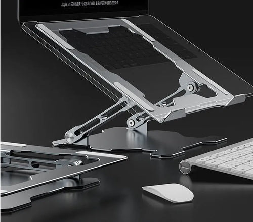 Grey aluminium folding laptop stand holding a silver laptop at an angle on a wooden desk.
