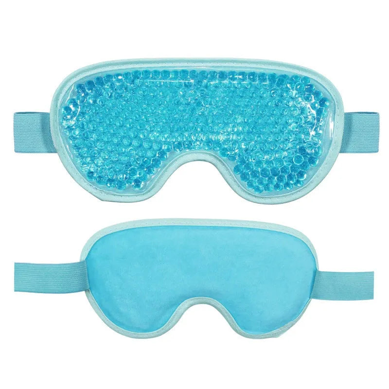 White portable rechargeable warm eye compress device and eye mask set on a table.