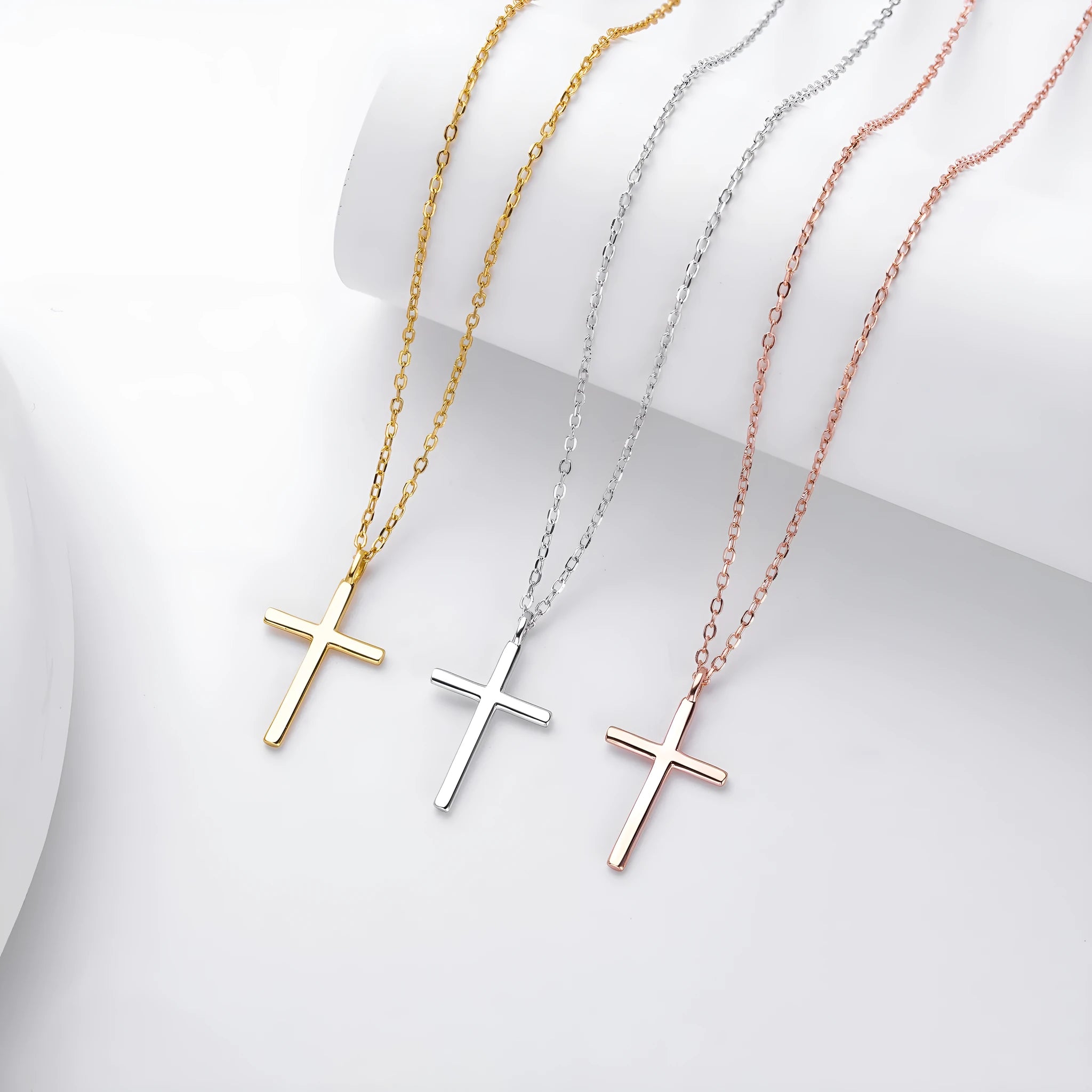 Sterling silver cross pendant necklace on an adjustable O-shaped chain, shown in gold plating.