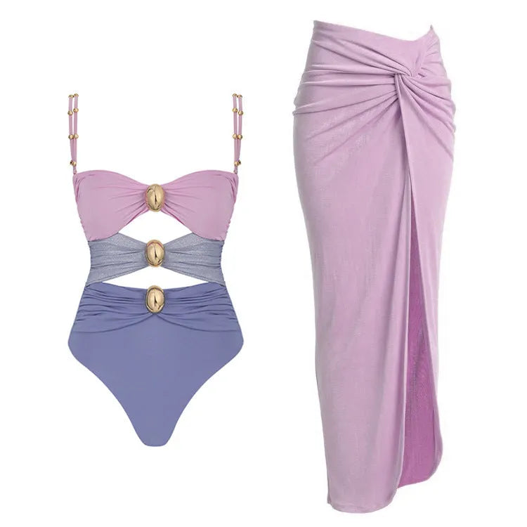 Women's one-piece swimsuit with matching skirt in assorted colours showing gold button detail