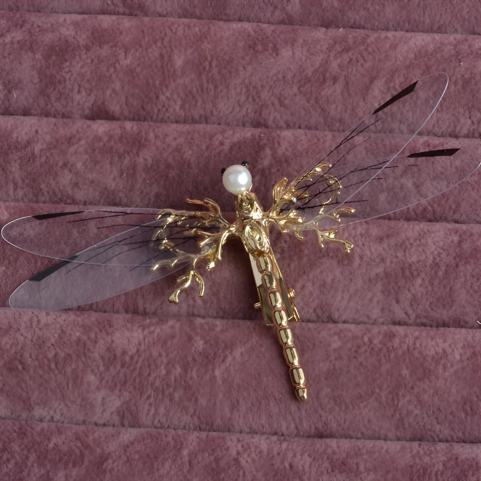 Golden alloy dragonfly-shaped side clip headdress for women on a white background.