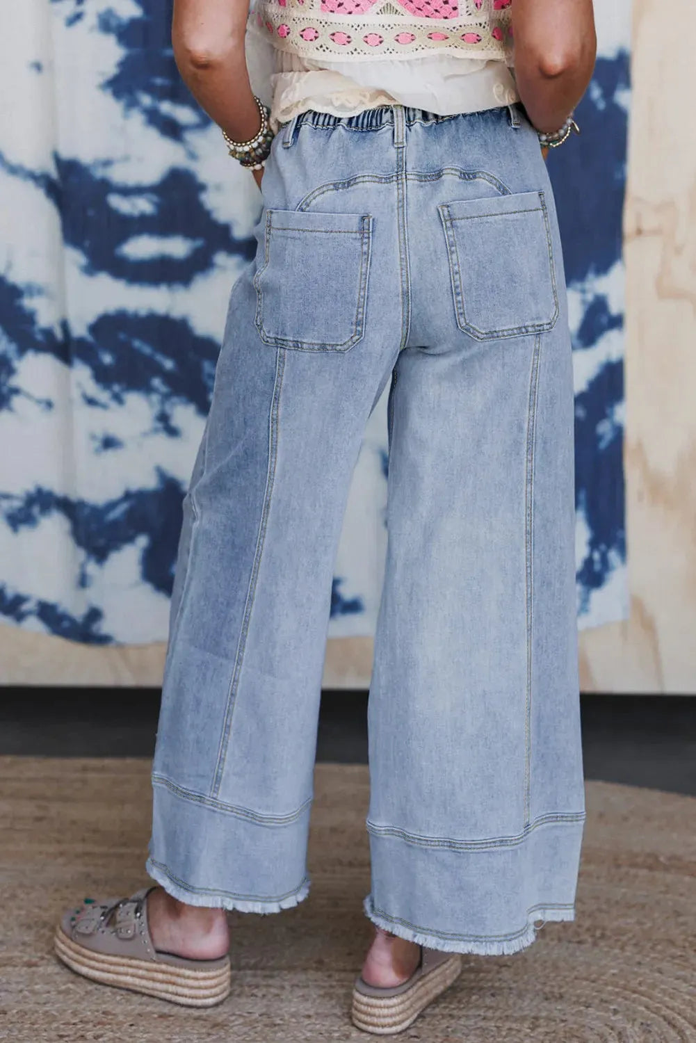 Beau blue women's wide leg denim trousers with drawstring waist and raw hem detail.