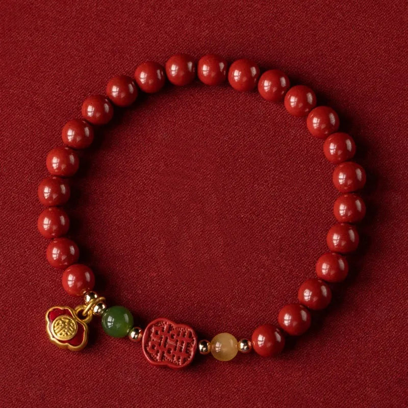 Chinese cinnabar bracelet with emperor sandstone beads and a carved fu character symbol.