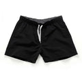 Men's straight-leg beach shorts in polyester fabric shown in a solid colour, laid flat.