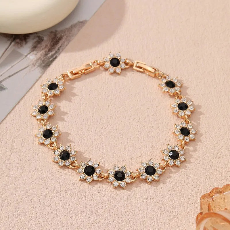Gold and silver electroplated flower bracelet with coloured gemstone accents on zinc alloy