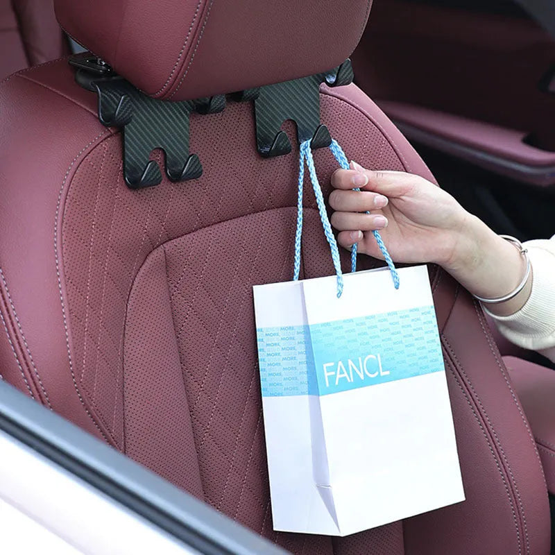 Black ABS plastic car multifunction hook bracket with integrated mobile phone holder for rear seat mounting.