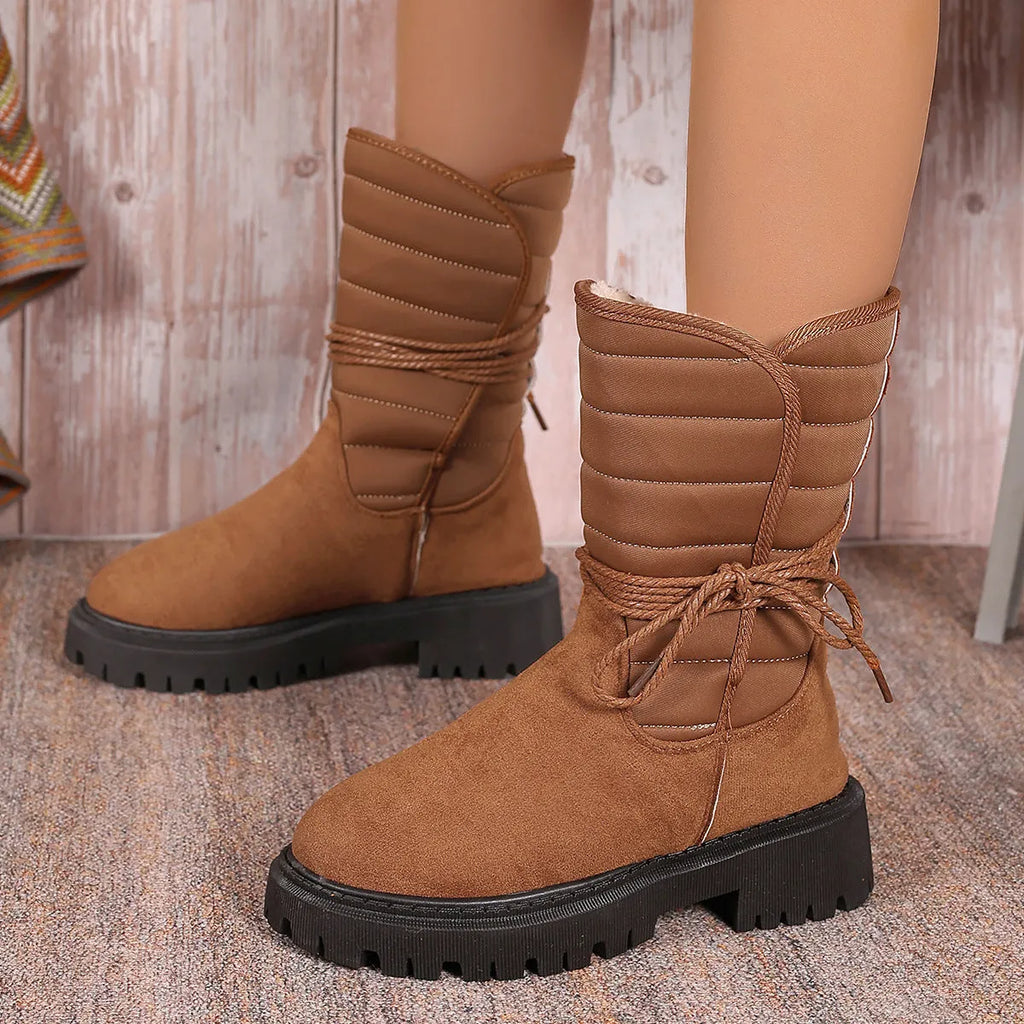 Women's black chunky heel snow boots with lace-up design and fleece lining.