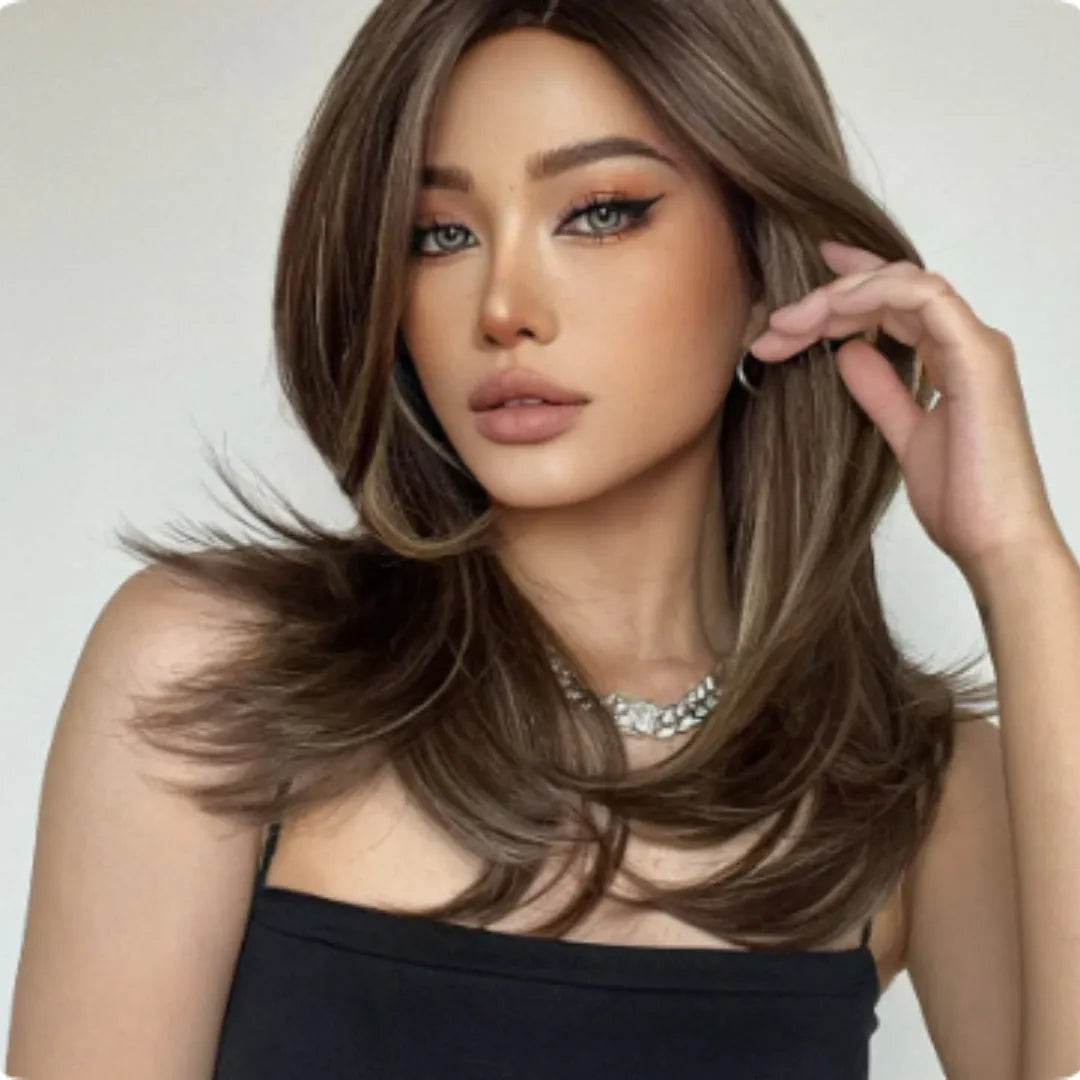 Mid-length curly full-head synthetic wig with long bangs in a platinum gradient colour.